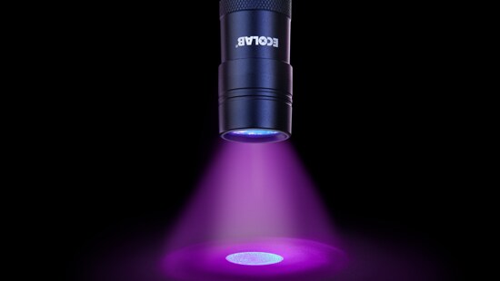 Flashlight sitting next to two tubes of DAZO fluorescent marking gel