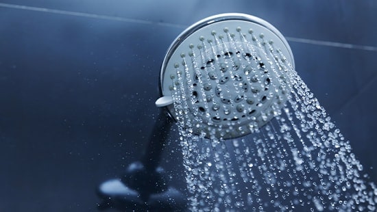 Showerhead with water flowing from it.