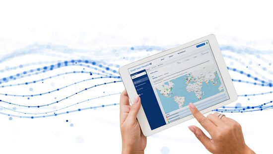 Hands holding a tablet showing a global dashboard in Ecolab Water Navigator IQ with a world map and data points.