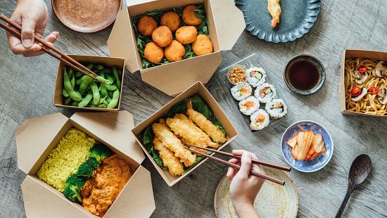 Japanese Food in Takeaway Containers Sitting on a Table